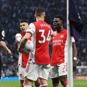 Arsenal's Martinelli, Xhaka, and Saka in Action against Tottenham in the Premier League Arsenal's Martinelli, Xhaka, and Saka in Action against Tottenham in the Premier League