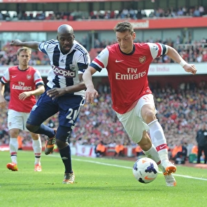 Arsenal's Mesut Ozil Faces Off Against West Brom's Yossouf Mulumbu in 2013-14 Premier League Clash