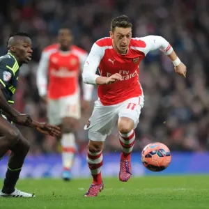 Arsenal's Mesut Ozil Outmaneuvers Middlesbrough's Albert Adomah in FA Cup Fifth Round Clash