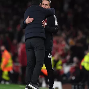 Arsenal's Mikel Arteta Embraces Assistant Coach Albert Stuivenburg After Arsenal v West Ham United Win
