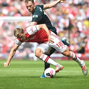 Arsenal's Monreal Clashes with Burnley's Barnes in Premier League Showdown