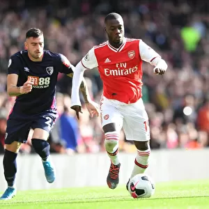 Arsenal's Nicolas Pepe Clashes with Bournemouth's Diego Rico in Premier League Showdown