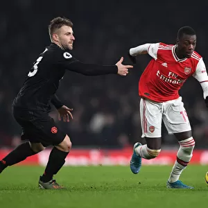 Arsenal's Nicolas Pepe Clashes with Manchester United's Luke Shaw in Premier League Showdown