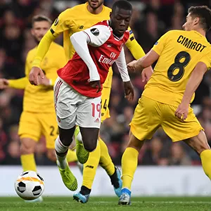 Arsenal's Nicolas Pepe Clashes with Standard Liege's Gojko Cimirot in Europa League Match