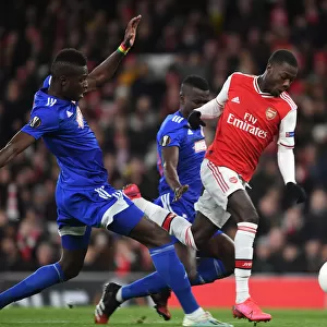 Arsenal's Nicolas Pepe Outmaneuvers Olympiacos Pape Abou Cisse in Europa League Clash