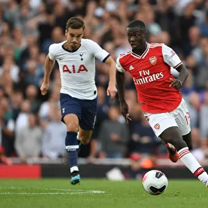 Arsenal's Nicolas Pepe Outmaneuvers Tottenham's Harry Winks in the 2019-20 Premier League Clash