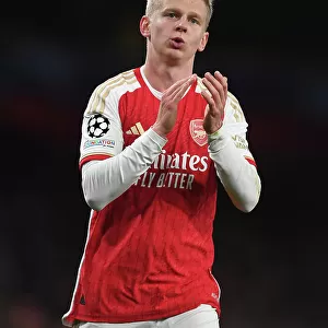 Arsenal's Oleksandr Zinchenko Celebrates with Fans after Victory over Sevilla in 2023-24 UEFA Champions League