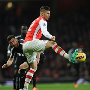 Arsenal's Olivier Giroud Faces Off Against Newcastle's Paul Dummett in Intense Premier League Clash