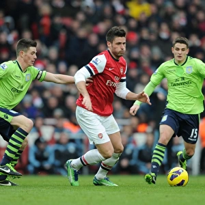 Arsenal's Olivier Giroud Fends Off Aston Villa's Defenders During Premier League Clash