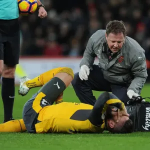 Arsenal's Olivier Giroud Receives Treatment from Physio during AFC Bournemouth Match, 2016-17