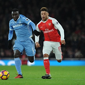 Arsenal's Oxlade-Chamberlain Clashes with Stoke's Diouf in Premier League Showdown