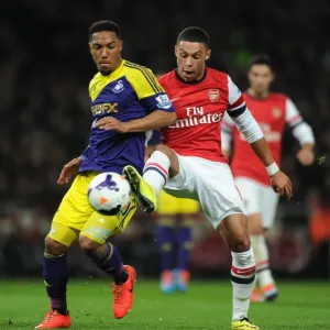 Arsenal's Oxlade-Chamberlain Faces Off Against Swansea's De Guzman