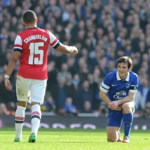 Arsenal's Oxlade-Chamberlain Offers A Hand to Everton's Baines in FA Cup Quarter-Final Arsenal's Oxlade-Chamberlain Offers A Hand to Everton's Baines in FA Cup Quarter-Final