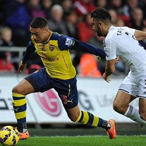 Arsenal's Oxlade-Chamberlain Outmaneuvers Swansea's Taylor in Premier League Clash (Swansea v Arsenal 2014-15)
