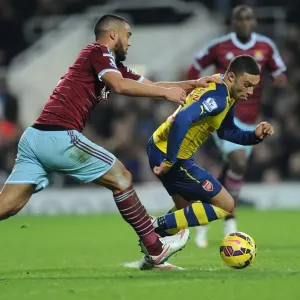 Arsenal's Oxlade-Chamberlain Outmaneuvers West Ham's Reid in Premier League Clash