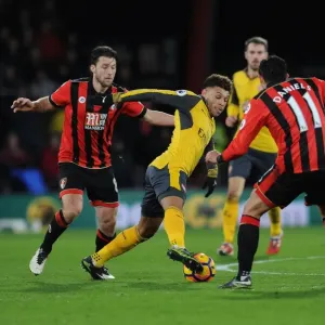 Arsenal's Oxlade-Chamberlain Stands Firm Against Bournemouth Duo Arter and Daniels in Intense Premier League Battle