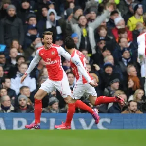 Arsenal's Ozil and Cazorla: Celebrating Glory Over Spurs in the 2015 Premier League Arsenal's Ozil and Cazorla: Celebrating Glory Over Spurs in the 2015 Premier League