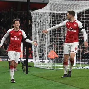 Arsenal's Ozil and Ramsey Celebrate Third Goal vs. Huddersfield Town, 2017-18 Season Arsenal's Ozil and Ramsey Celebrate Third Goal vs. Huddersfield Town, 2017-18 Season