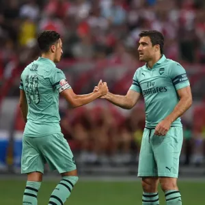 Arsenal's Ozil and Sokratis: Unity in Victory - Celebrating a Goal Against Paris Saint-Germain in the 2018 International Champions Cup (Singapore)