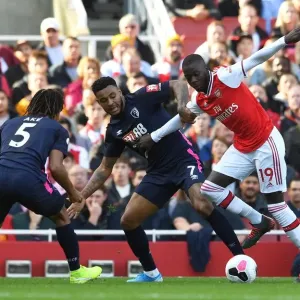 Arsenal's Pepe Clashes with Bournemouth's King and Ake during the 2019-20 Premier League Match Arsenal's Pepe Clashes with Bournemouth's King and Ake during the 2019-20 Premier League Match