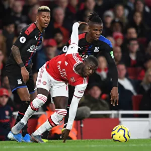 Arsenal's Pepe Clashes with Palace's Van Aanholt and Zaha during the 2019-20 Premier League Match