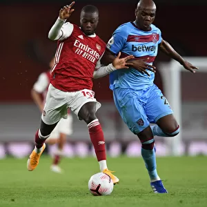 Arsenal's Pepe Clashes with West Ham's Ogbonna in Premier League Showdown