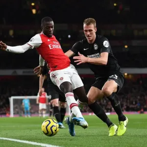 Arsenal's Pepe Faces Off Against Brighton's Burn in Premier League Clash