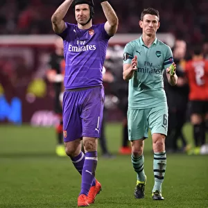Arsenal's Petr Cech and Laurent Koscielny Celebrate with Fans after First Leg of Europa League Match against Stade Rennais