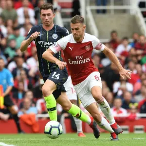 Arsenal's Ramsey Clashes with Manchester City's Laporte in Premier League Showdown