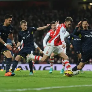 Arsenal's Ramsey Clashes with Southampton's Yoshida and Davis during Premier League Match