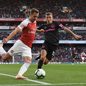 Arsenal's Ramsey Faces Off Against Everton's Digne in Premier League Clash