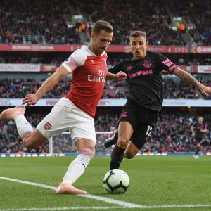 Arsenal's Ramsey Faces Off Against Everton's Digne in Premier League Clash