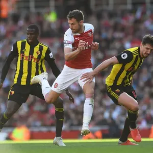 Arsenal's Ramsey Fends Off Doucoure and Cathcart Pressure During Arsenal v Watford Match