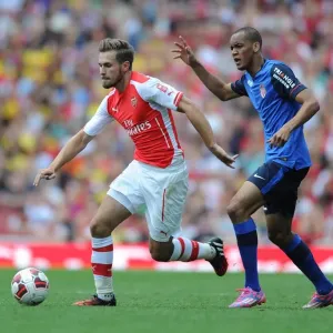 Arsenal's Ramsey Outmaneuvers Monaco's Fabinho in Emirates Cup Clash