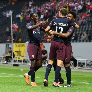 Arsenal's Reiss Nelson, Eddie Nketiah, and Stephan Lichtsteiner Celebrate Goal Against SS Lazio in 2018 Pre-Season Friendly Arsenal's Reiss Nelson, Eddie Nketiah, and Stephan Lichtsteiner Celebrate Goal Against SS Lazio in 2018 Pre-Season Friendly