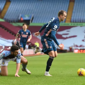 Arsenal's Rob Holding Outmaneuvers Aston Villa's John McGinn in Empty Villa Park