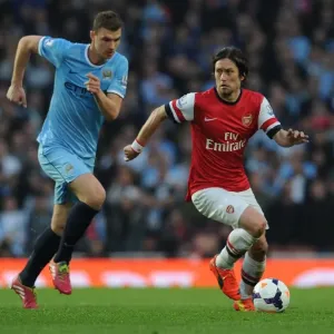 Arsenal's Rosicky Outmaneuvers Manchester City's Dzeko in Thrilling Premier League Clash