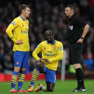 Arsenal's Sagna and Ramsey Confer with Referee Oliver during Manchester United Clash (2013-14) Arsenal's Sagna and Ramsey Confer with Referee Oliver during Manchester United Clash (2013-14)