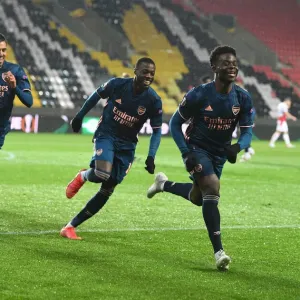 Arsenal's Saka, Ceballos, and Pepe: Empty Eden Arena Goal Celebrations during UEFA Europa League Quarterfinals Arsenal's Saka, Ceballos, and Pepe: Empty Eden Arena Goal Celebrations during UEFA Europa League Quarterfinals