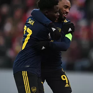 Arsenal's Saka and Lacazette: Celebrating Goals in Europa League Victory over Standard Liege