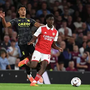 Arsenal's Sambi Outmaneuvers Aston Villa's Ollie Watkins in 2022-23 Premier League Clash