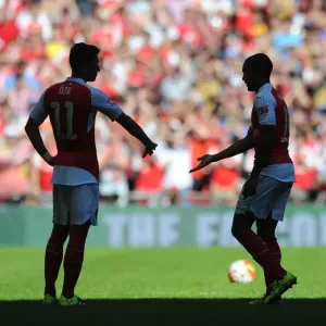 Arsenal's Star Duo: Ozil and Walcott Shine at the FA Community Shield vs. Chelsea (2015) Arsenal's Star Duo: Ozil and Walcott Shine at the FA Community Shield vs. Chelsea (2015)