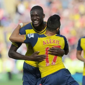 Arsenal's Star Duo: Sanchez and Sanogo in Glory: Celebrating a Goal Against Leicester City (2014-15)