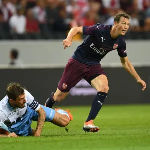 Arsenal's Stephan Lichtsteiner Clashes with Lazio's Francesco Acerbi in Pre-Season Friendly Arsenal's Stephan Lichtsteiner Clashes with Lazio's Francesco Acerbi in Pre-Season Friendly