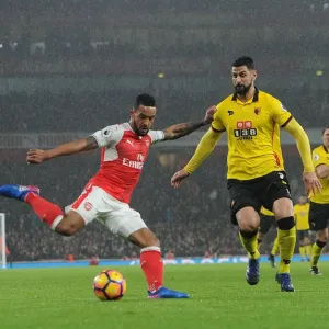 Arsenal's Theo Walcott Battles Past Watford's Miguel Britos in Premier League Clash