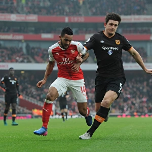 Arsenal's Theo Walcott Faces Off Against Hull's Harry Maguire in Premier League Clash