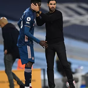 Arsenal's Thomas Partey Receives Strategic Guidance from Mikel Arteta during Manchester City Match (2020-21)