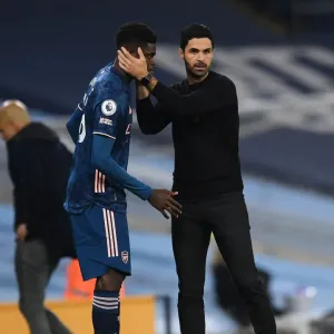Arsenal's Thomas Partey Receives Strategic Guidance from Mikel Arteta during Manchester City Match (2020-21) Arsenal's Thomas Partey Receives Strategic Guidance from Mikel Arteta during Manchester City Match (2020-21)
