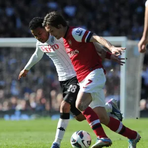 Arsenal's Tomas Rosicky Fends Off Urby Emanuelson in Intense Fulham Clash Arsenal's Tomas Rosicky Fends Off Urby Emanuelson in Intense Fulham Clash