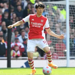 Arsenal's Tomiyasu in Action: Premier League Showdown against Manchester United at Emirates Stadium Arsenal's Tomiyasu in Action: Premier League Showdown against Manchester United at Emirates Stadium